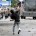 A protestor throws rocks at riot police